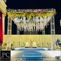 A wider shot of the stunning floral and crystal mandap, showcasing its grand structure and the beautiful play of light. This is how I make Jaimala moments truly magical.