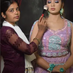 My students learn to create a variety of looks. This image shows a student working on a soft glam party look with a beautiful lavender and turquoise lehenga.