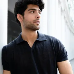 This portrait from a men's fashion shoot highlights a relaxed yet polished look. We used the clean lines of the architecture as a backdrop to complement the model's classic polo shirt, creating a timeless image for his portfolio.