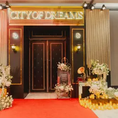 A night inspired by the city that never sleeps. Moody lights, gold tones, and a bit of old-school glamour brought this "City of Dreams" theme to life for a chic pre-wedding party.