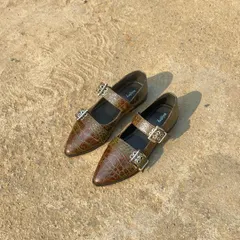 The buckled ballet flat in a unique olive-brown croc finish. This color has a beautiful, subtle variation in tone that makes it a sophisticated and versatile neutral for any season.