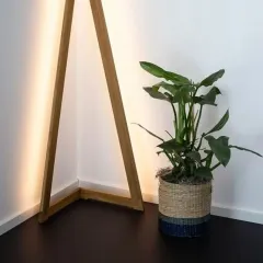 We believe lighting can be art. This unique triangular wooden floor lamp adds a modern and sculptural element to a room corner.