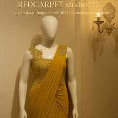 This mustard yellow pre-draped saree gown is designed for making a statement. The outfit is built around a corseted bodice with intricate floral embroidery that extends over the shoulder, while the lycra fabric creates beautiful, fluid drapes.