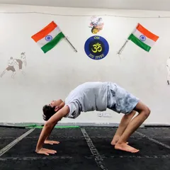 Happy International Yoga Day. A student demonstrates a perfect wheel pose (Chakrasana), showing the flexibility and strength that yoga builds. Yoga is an integral part of our training.