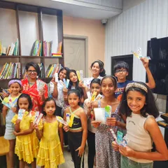 A group of proud young artists showing off the bookmarks they created during our "Doodle Summer Fun" workshop. It was a day of creative expression where everyone learned the basics of doodling.
