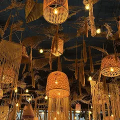 The ceiling decor for the boho reception was a work of art. We used a dense arrangement of dried botanicals, macrame hangings, and woven basket lamps to create a warm, rustic, and incredibly detailed look.