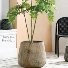 Here is another look at the Timeless Leaf Series planter, showing how its earthy texture and design can anchor a corner of a room. Paired with a leafy plant, it creates a sense of peace and endurance, a perfect addition to any home decor.