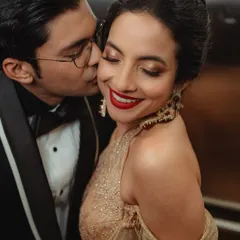 A close-up of Tessa's reception glam. We paired a classic red lip with luminous, golden-shimmer eyes. This look is all about creating a statement that is both bold and elegant, perfect for a night of celebration.