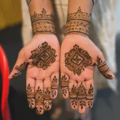 A simple yet elegant design featuring a diamond-shaped geometric motif in the center of each palm. The matching wristbands and finger details create a very cohesive and symmetrical look.