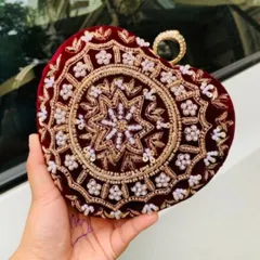 This heart-shaped clutch in deep red velvet shows the intricate beadwork and embroidery I do. Even without names, the detailed craftsmanship makes it a stunning bridal accessory.