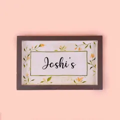 A simple and elegant floral nameplate, one of our most loved designs. The delicate, hand-painted vines create a beautiful border for the family name, offering a warm welcome.