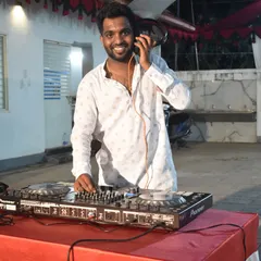 Listening closely to the next track in my headphones. This is a key part of DJing, ensuring the next song mixes perfectly to keep the party's momentum going.
