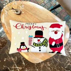 New arrival alert. This festive Christmas cushion cover features a cheerful Santa, snowman, and penguin, sure to bring the holiday spirit to your living room.