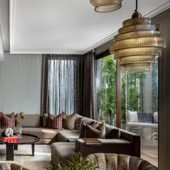 In the House of Two Worlds, we crafted intimate living spaces that are warm, light-filled, and personal. This view showcases the balance between luxurious comfort and a direct connection to the outdoors, a core principle in our residential architecture.