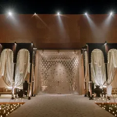 The grand entrance to the Sufi night venue, featuring towering archways and an intricately designed door. The path is lit by hundreds of candles, setting a magical and reverent tone for the evening.