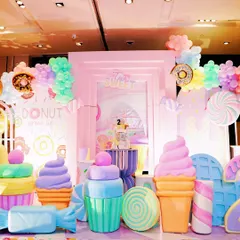 Another perspective of the Candyland stage, highlighting the layered backdrop and the arrangement of colorful, oversized sweet treat props.