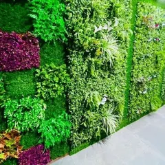 An example of a dense, textured artificial green wall. For areas with no sunlight or for clients who want a zero-maintenance option, I also design and install high-quality artificial vertical gardens.