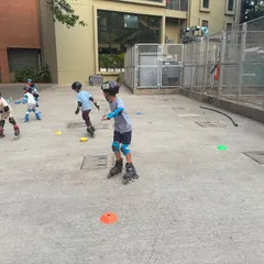 Kids in motion during a group skating class. You can see the varying levels of skill, but everyone is participating and having fun, which is what our program is all about.