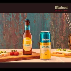 Presenting the Mahou Wheat variant in both bottle and can formats. The rustic blue background and simple food pairings create a visually distinct look for this product line.