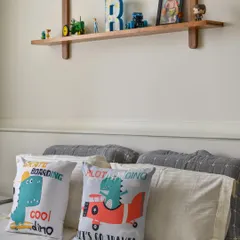 This kid's room from our 'Malhar' project features a custom wooden ledge for holding books and toys. The design is both functional and charming, adding a touch of craftsmanship to the space.