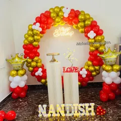 This royal-themed birthday decoration features a circular balloon arch in red and gold. I added fun details like balloon columns topped with gold crowns and marquee letters spelling out the name.