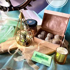 A slightly different take on a platter, this hamper features a beautiful mango wood cheeseboard. It's a versatile gift that can be used long after the festivities are over. We pair it with an air plant, a candle, granola, and a box of delicious upcycled sweets.