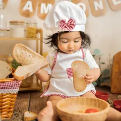 Inspecting the ingredients. This little chef is very serious about her bread, making for an adorable and funny themed portrait.