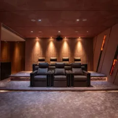 We create bespoke entertainment spaces that are both immersive and stylish. This private home theater features tiered seating, professional-grade acoustics, and dramatic onyx-panel lighting, crafting the ultimate cinematic experience right at home.