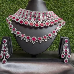 A stunning two-layered choker featuring sparkling AD work and rich ruby stones. This piece is a showstopper, perfect for a bride's reception or any grand celebration.