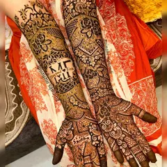 A full view of Fiza's bridal henna, with the initials "M" and "F" and their names, Maqsood and Fiza, beautifully integrated into the arm design.