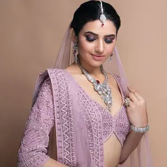 Our custom stitching service allows for breathtaking results. This lavender blouse features intricate beadwork and a modern deep V-neckline, perfectly tailored to create a stunning silhouette for a wedding or reception.