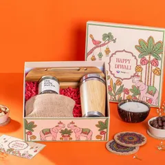 A Diwali hamper from Swageasy, styled against a bright orange background. The box contains a mix of modern and traditional items, like a bamboo tumbler and dry fruits, appealing to a corporate gifting audience.