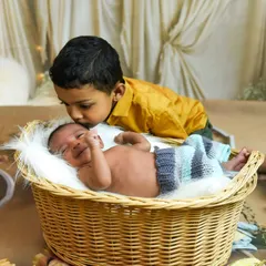 A sweet kiss for the new baby. We love including older siblings in newborn photoshoots to capture the start of their beautiful bond.