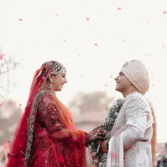 A romantic side-profile shot of the couple during their Varmala ceremony.