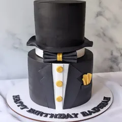 A sophisticated tuxedo and top hat cake designed for a CEO's birthday. This "Gentleman's theme" cake is elegant and formal, perfect for celebrating a leader with style.