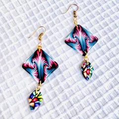 These dangler earrings are made from polymer clay with a mesmerizing psychedelic pattern. They are incredibly lightweight, so you can wear them all day long.