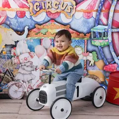 Welcome to the carnival! This vibrant and playful theme is perfect for celebrating a milestone. With a colorful circus backdrop and fun props like a retro toy car, we create a world of fun and excitement.