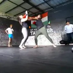 This action shot captures the intensity of a women's boxing match. Our student, a radiation oncologist by profession, demonstrates incredible courage and skill, proving that anyone can learn to fight with the right training and mindset.