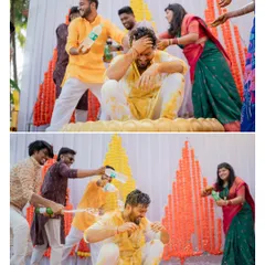 The groom's friends playfully douse him with water during a fun-filled Haldi celebration. I love capturing these candid, high-energy moments.