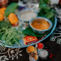 A close-up shot of the traditional items on a puja thali for an engagement ceremony. These detail shots preserve the cultural richness of your event.