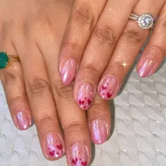 A little love on your nails. This sweet and simple design features a shimmery, pearlescent pink base with accent nails adorned with tiny, hand-painted red hearts.
