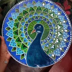The finished 17-inch peacock Lippan art, a symbol of grace and beauty. The combination of paint and mirror work creates a stunning effect as it catches the light.