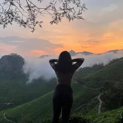 A moment of peace, looking out over the endless green tea plantations of Munnar as the sun sets.