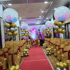 An elegant and premium decoration for a baby shower. We lined the aisle with beautiful balloon stands in gold, silver, and pastel colors, leading up to the main stage and creating a grand entrance for the parents-to-be.
