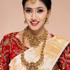 A classic South Indian bridal portrait, featuring a model in a traditional red and white saree with elaborate gold temple jewellery. My studio is equipped to handle all types of traditional wear shoots.