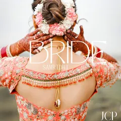 A creative bridal portrait focusing on the beautiful floral hair bun and intricate blouse back.