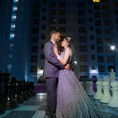 A stunning night-time portrait of a couple on a giant chessboard. This creative and dramatic shot is perfect for a glamorous reception or engagement shoot.