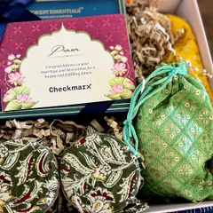 A closer look at a modern Indian gift box. It includes items from Forest Essentials, dry fruits in Kalamkari-print jars, and a sequined potli, all curated to create a rich tapestry of textures and colors.