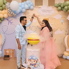 Adventure is in the air! This gender reveal used a vibrant smoke bomb to announce the baby's gender against a whimsical travel-themed backdrop. It’s a dynamic and colorful way to celebrate the journey ahead.