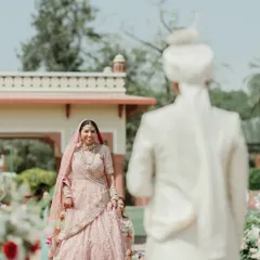 The groom's first look at his bride walking down the aisle at the Jai Mahal Palace in Jaipur. A candid, emotional moment that is the heart of any wedding story.